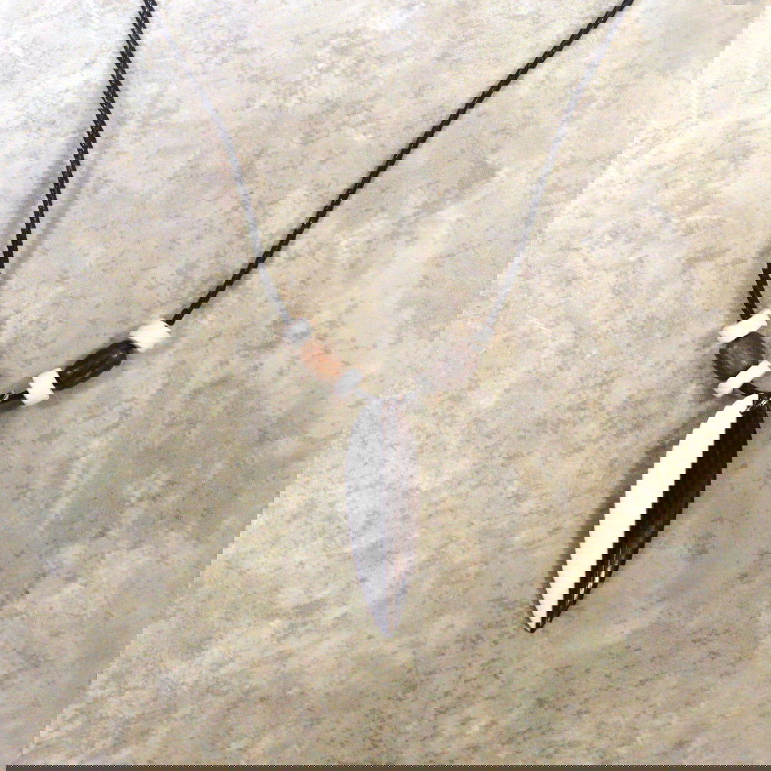 Adjustable necklace featuring a wooden and bone surfboard design, showcasing a tropical-inspired style perfect for beach lovers.