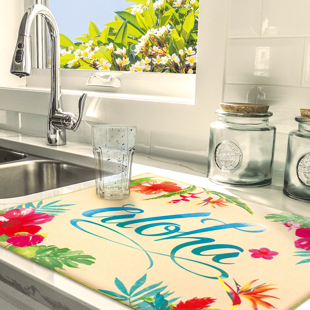 Lifestyle photo of a kitchen sink and an aloha floral drying mat