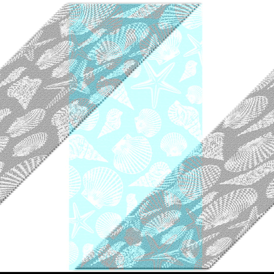Beach towel featuring a teal design adorned with various seashells, showcasing vibrant colors and a beach-inspired theme, perfect for seaside relaxation.