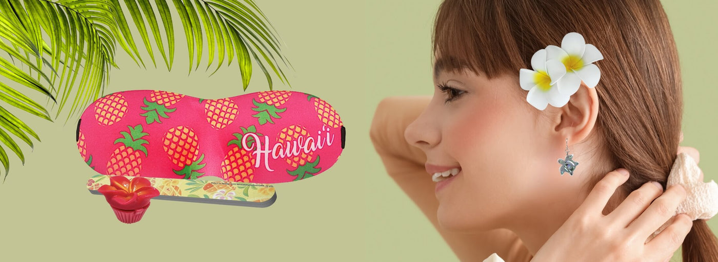 Banner with tropical plants and flowers, profile of a woman with turtle earrings, Hawaii eye mask, emery board and lip gloss.