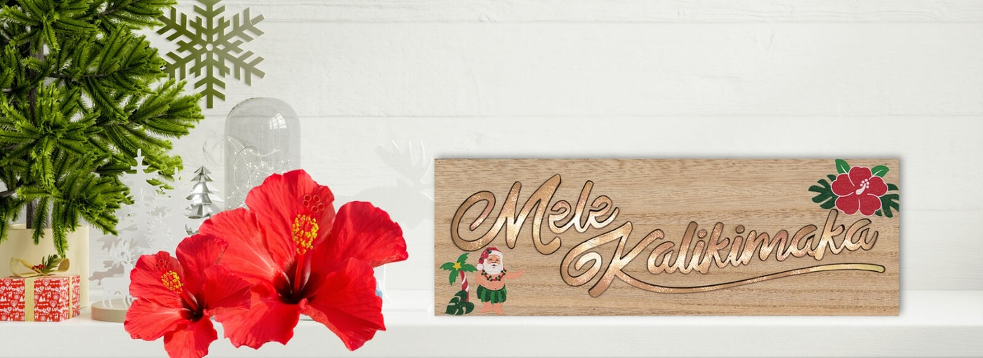Banner with tropical flowers and Christmas decor with Hawaii Mele Kalikimaka wooden sign.