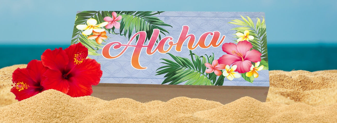 flowers and sand with a tropical Hawaii aloha sign.
