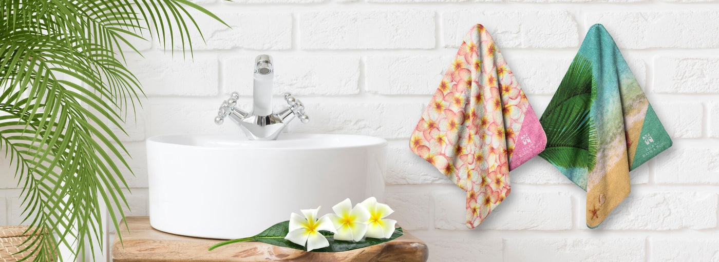 Banner with tropical plants and flowers, a bathroom sink and Hawaii hand towels.