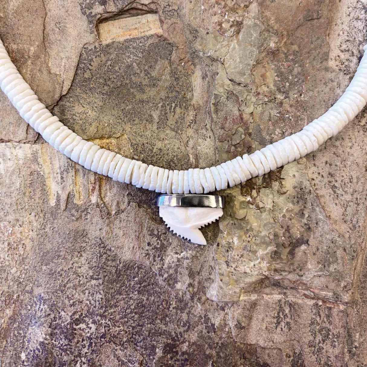 Ethically sourced white clam necklace featuring hand-strung sharktooth charm
