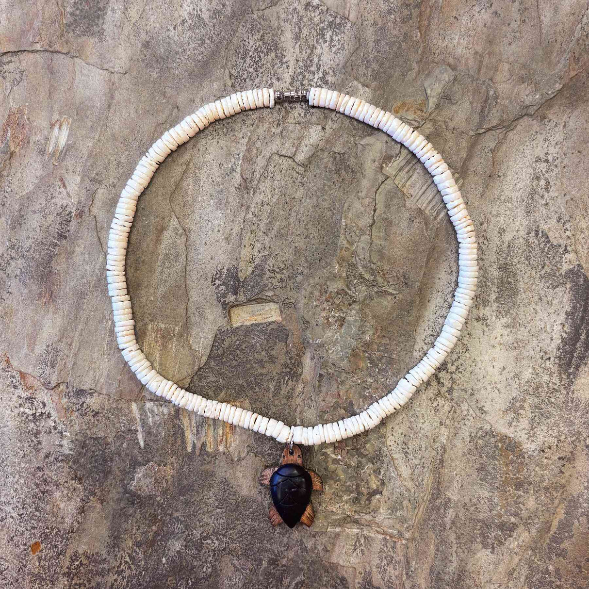 White clam shell necklace featuring a handcrafted wood turtle charm inspired by Hawaiian sea life