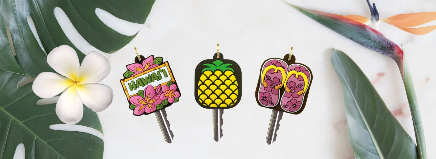Island Heritage's key covers collection banner, featuring vibrant Hawaii-inspired designs to protect your keys in style