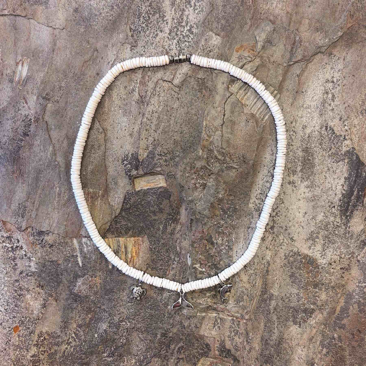 Island-inspired necklace adorned with three ocean-style charms and white clam accents