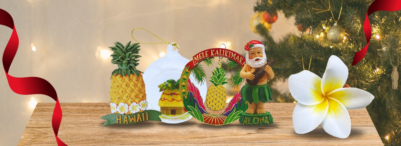 Christmas scene with tree, ribbon, flower and Hawaii Mele Kalikimaka aloha, pineapple, and Santa ornaments.