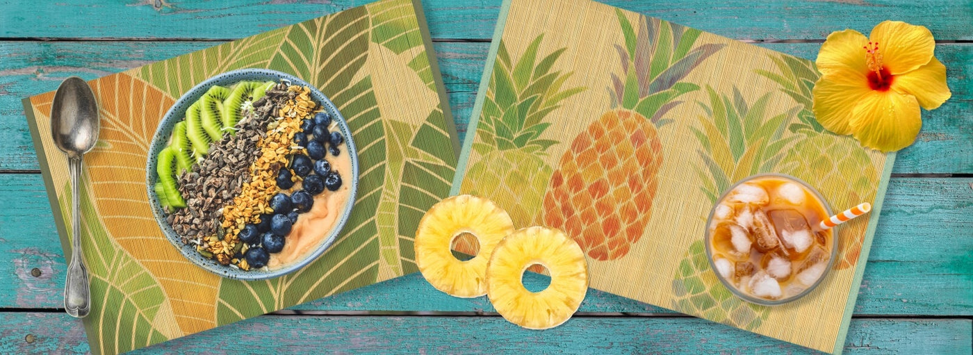 Banner with blue wood background, Hawaii mats with bowel of food, a spoon, pineapples, and soda with straw.