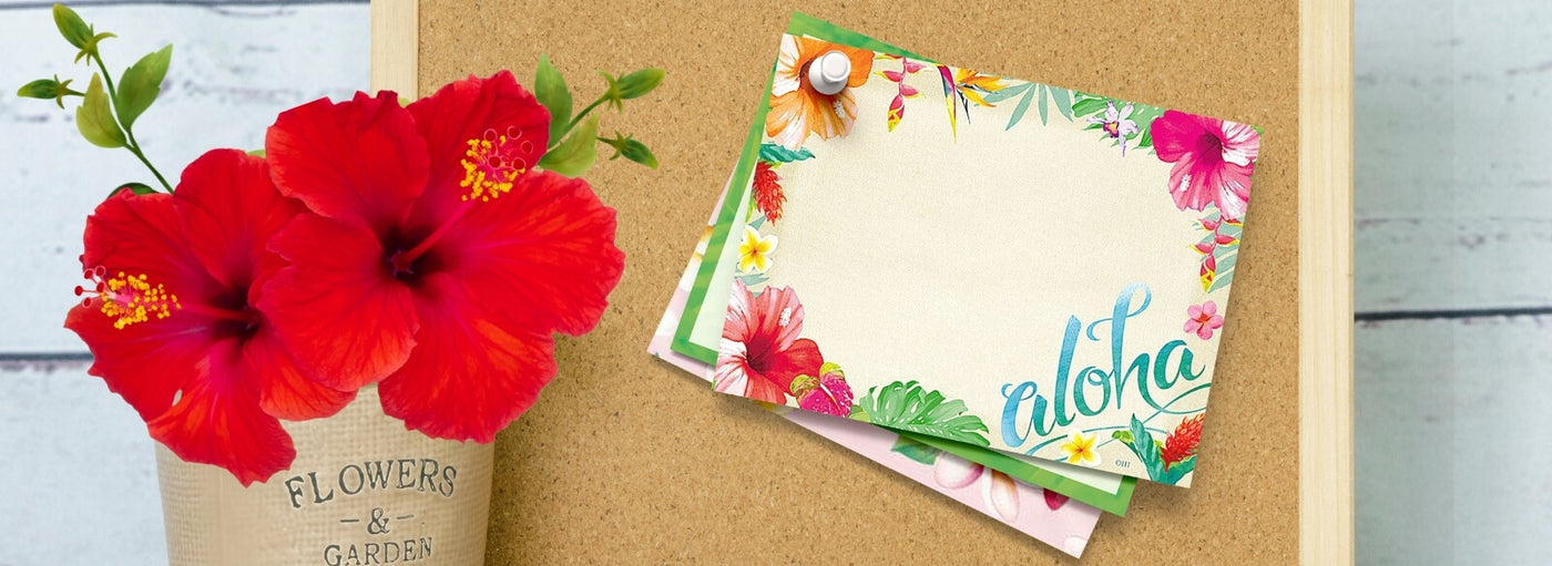 Banner with cork board, flowers and Hawaii aloha notes pinned.