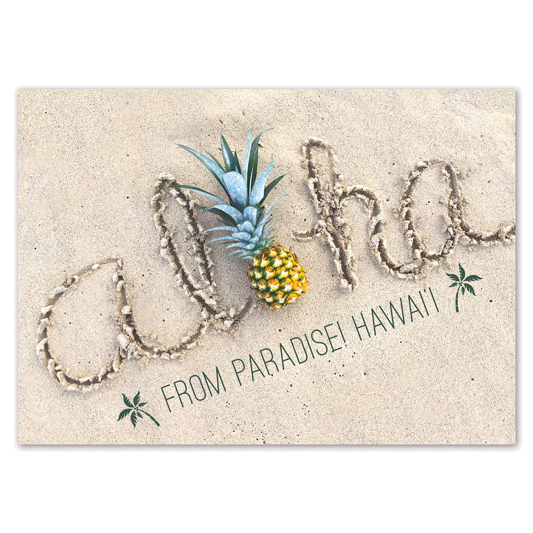 Postcard with a pineapple and 'aloha' text on sand, featuring 'From Paradise! Hawaii!' text.