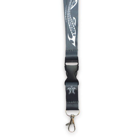 A black lanyard with a lobster clasp and a tribal honu design, detachable bottom half, for holding keys or ID cards.