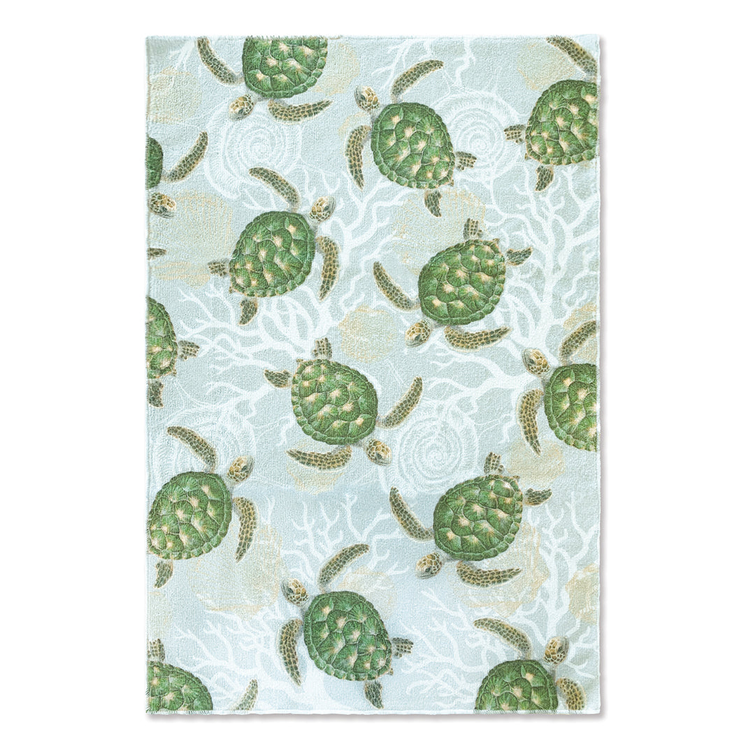 A blue microfiber kitchen towel with Hawaiian sea turtles.