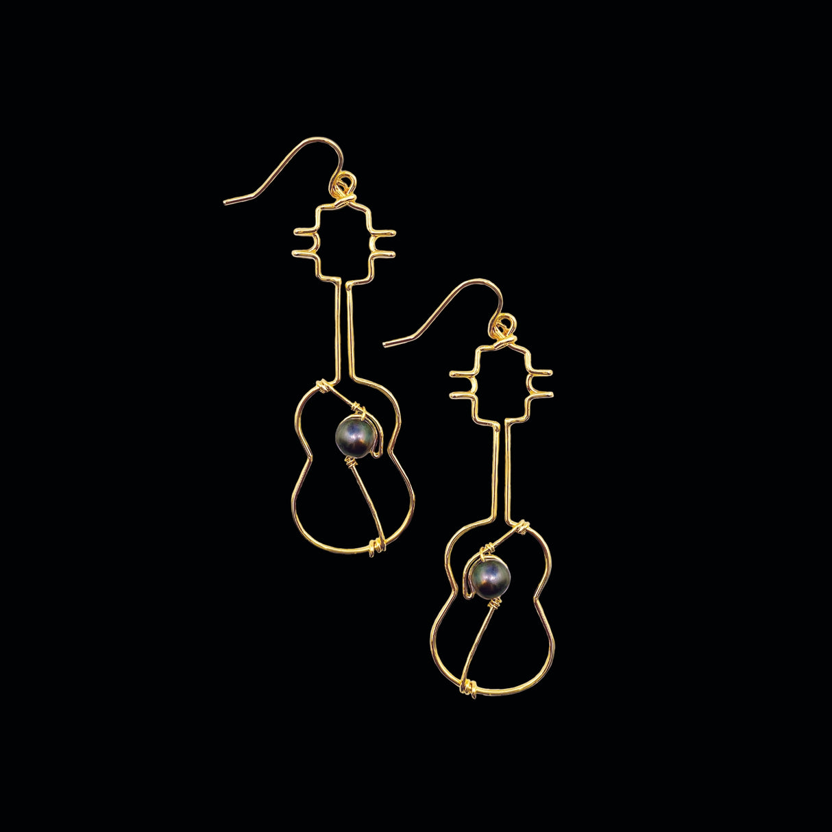 Gold ukulele Earrings with Black Pearls, showcasing their unique design and lightweight structure
