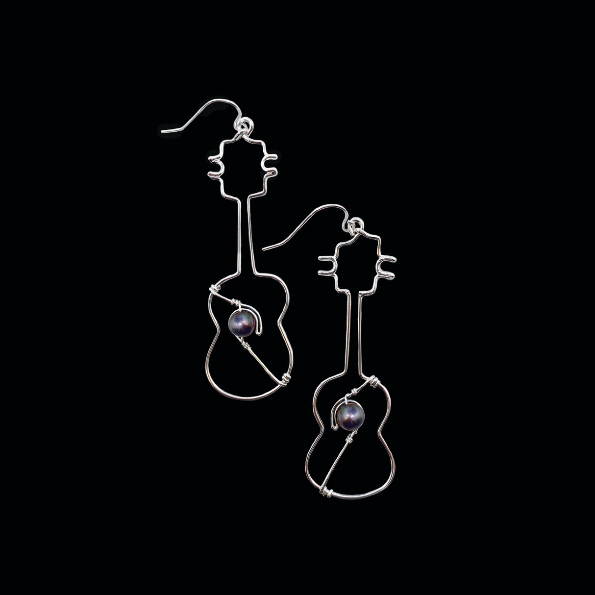Silver Ukulele Earrings with Black Pearls, showcasing their unique design and lightweight structure