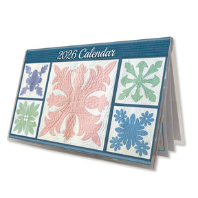Quilted 2026 pocket calendar showing side view with colorful fabric patterns.
