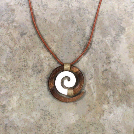 Adjustable necklace featuring a brown wood and bone design with a Koru motif, symbolizing new beginnings and growth, perfect for adding a touch of nature-inspired elegance.