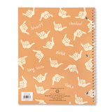 Back of a composition book with orange background and Hawaii words and shakas.