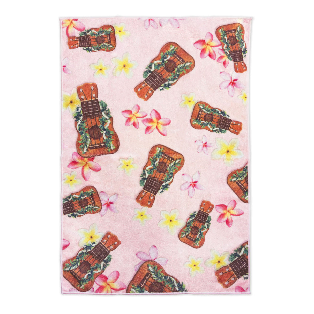 Patterned towel with ukuleles and plumeria flowers on a pink background