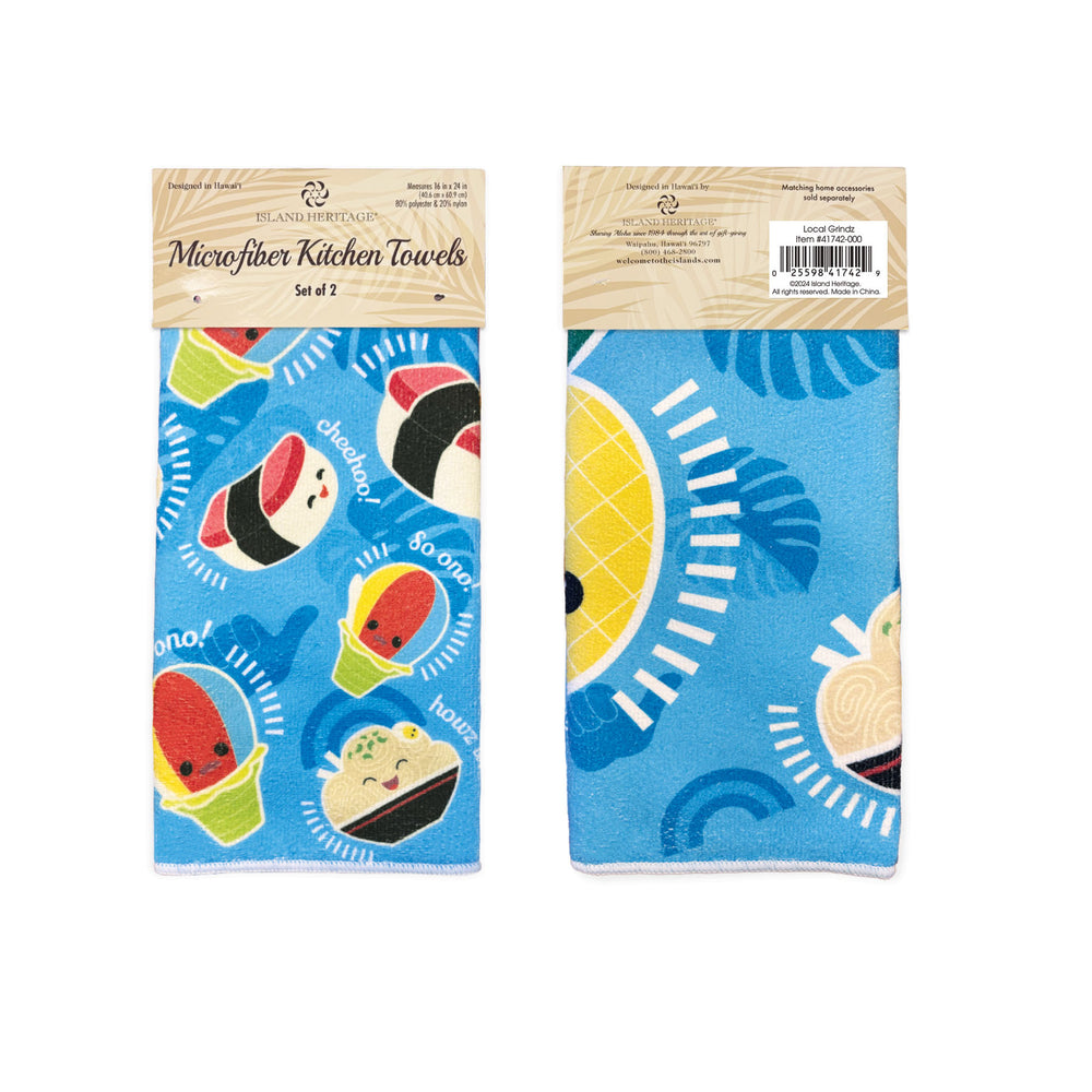 Two microfiber kitchen towels with cartoon food designs in their packaging on a white background.