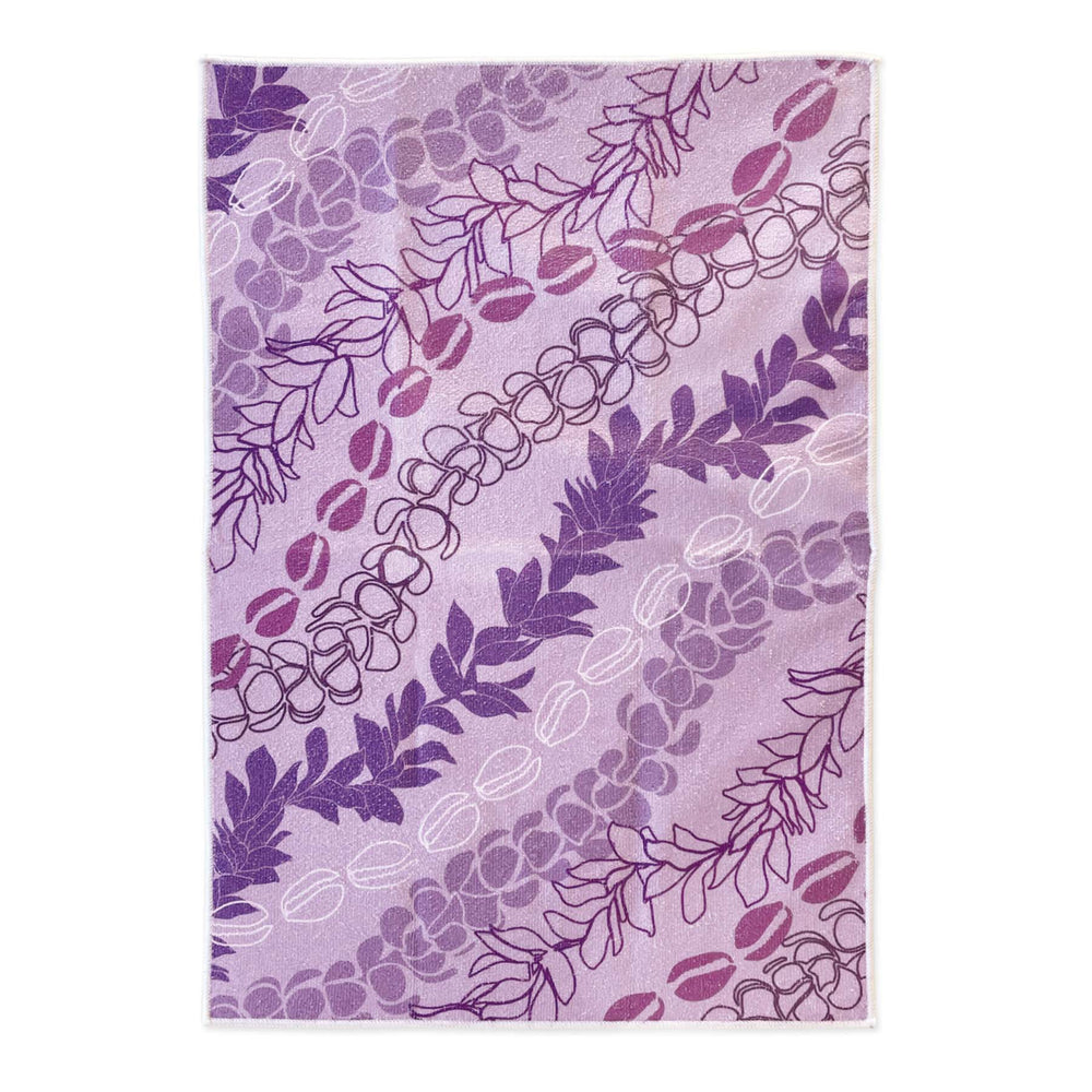 Purple lei floral patterned kitchen towel on a white background