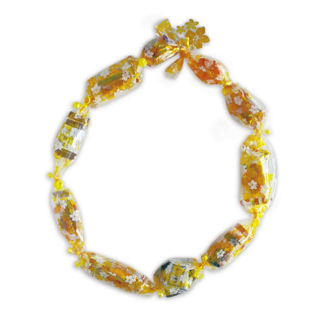 Candy Lei Kit, Hibiscus Lei in gold, shown in a mockup with the kit's contents and elegant hibiscus floral design for crafting colorful leis.