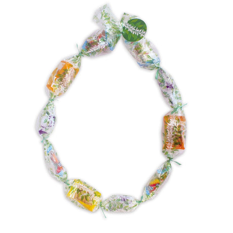 Candy Lei Kit, Maile in green, displayed in a mockup with Maile leaf accents and kit contents for a vibrant candy lei crafting session.