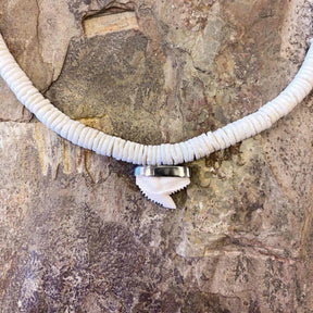 Ethically sourced white clam necklace featuring hand-strung sharktooth charm