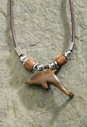Rubber cord necklace featuring a wooden dolphin pendant, showcasing a charming and tropical-inspired design perfect for ocean lovers.