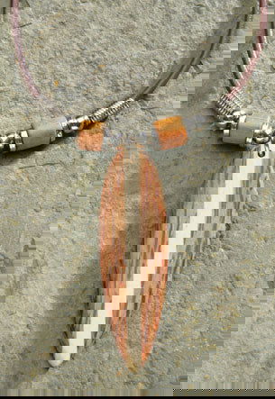 Rubber cord necklace featuring a wooden surfboard pendant made from coconut wood, showcasing a unique and tropical-inspired design.