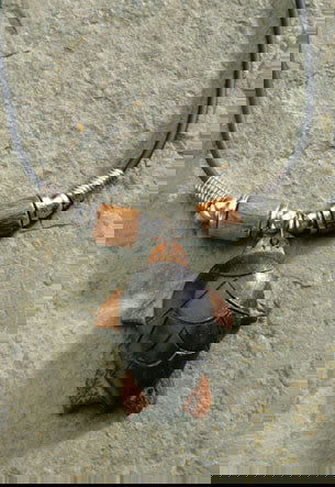 Rubber cord necklace featuring a wooden turtle pendant, showcasing a unique and stylish design inspired by tropical themes.