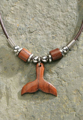 Rubber cord necklace featuring a wooden whale tail pendant, showcasing a stylish design inspired by marine life and tropical themes.