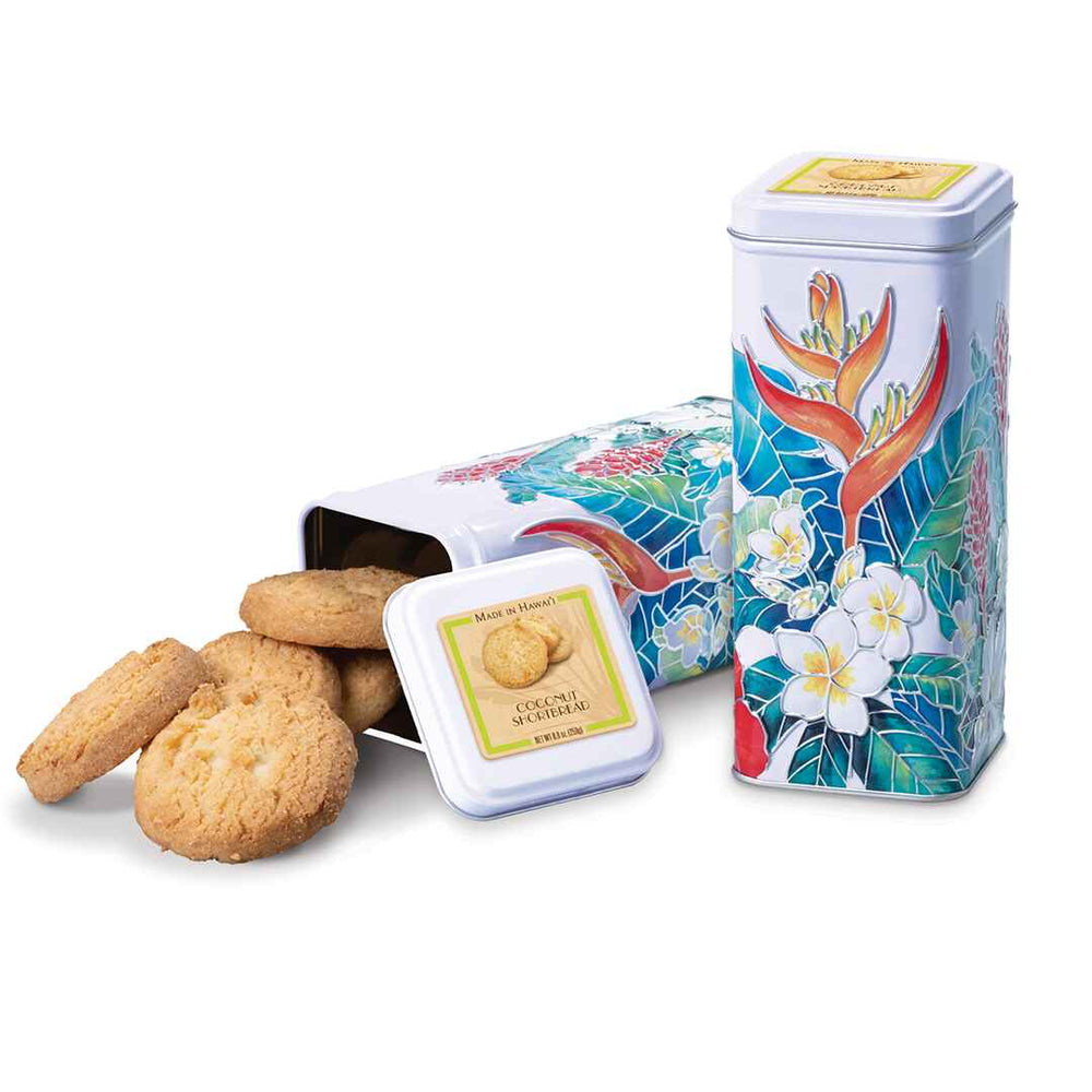 A tall cookie tin with a colorful, floral design, alongside several coconut shortbread cookies placed outside of the tin.