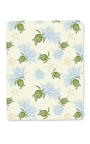 Travel blanket with strap featuring a Honu Voyage design, showcasing colorful sea turtles and tropical patterns, perfect for keeping warm on the go.