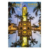 Aloha Tower with palm trees and reflection in water at dusk