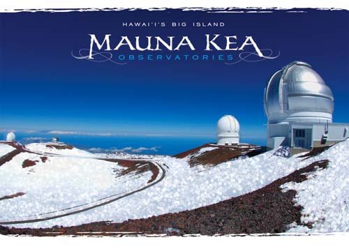 Mauna Kea Observatories on Hawaii's Big Island with snow-covered ground and clear blue sky.