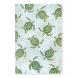 A blue microfiber kitchen towel with Hawaiian sea turtles.