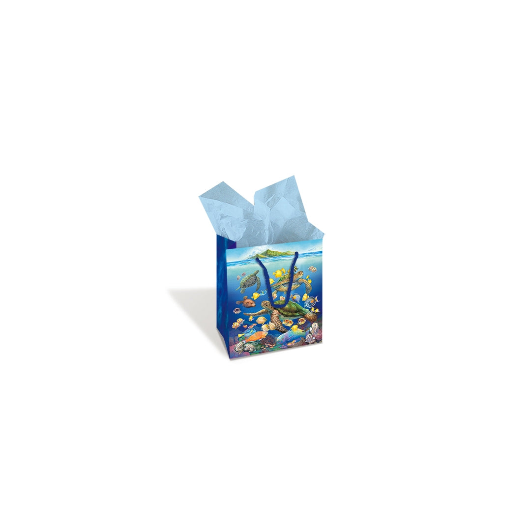 A Hawaii blue underwater sea turtle themed gift bag with tissue paper in it.