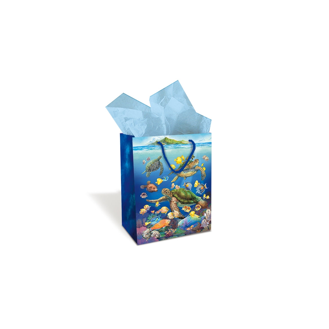 A Hawaii blue underwater sea turtle themed gift bag with tissue paper inside.