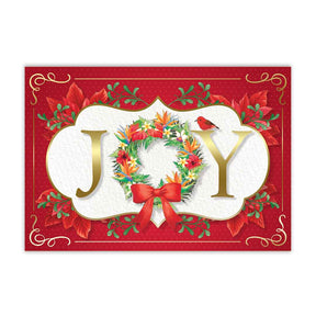 A Christmas card with a floral wreath and the word 'JOY' in the center.