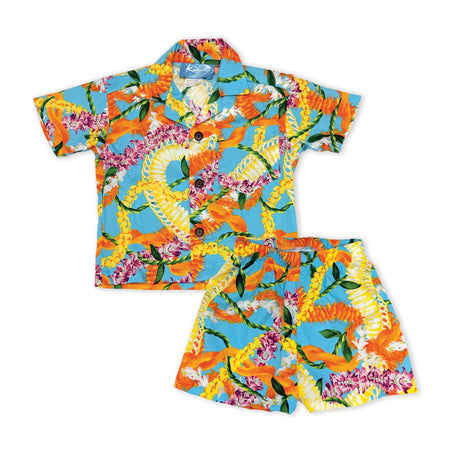A two-piece kids' Hawaiian shirt and shorts set featuring a vibrant tropical print with orange, yellow, pink, and white flowers on a light blue background.