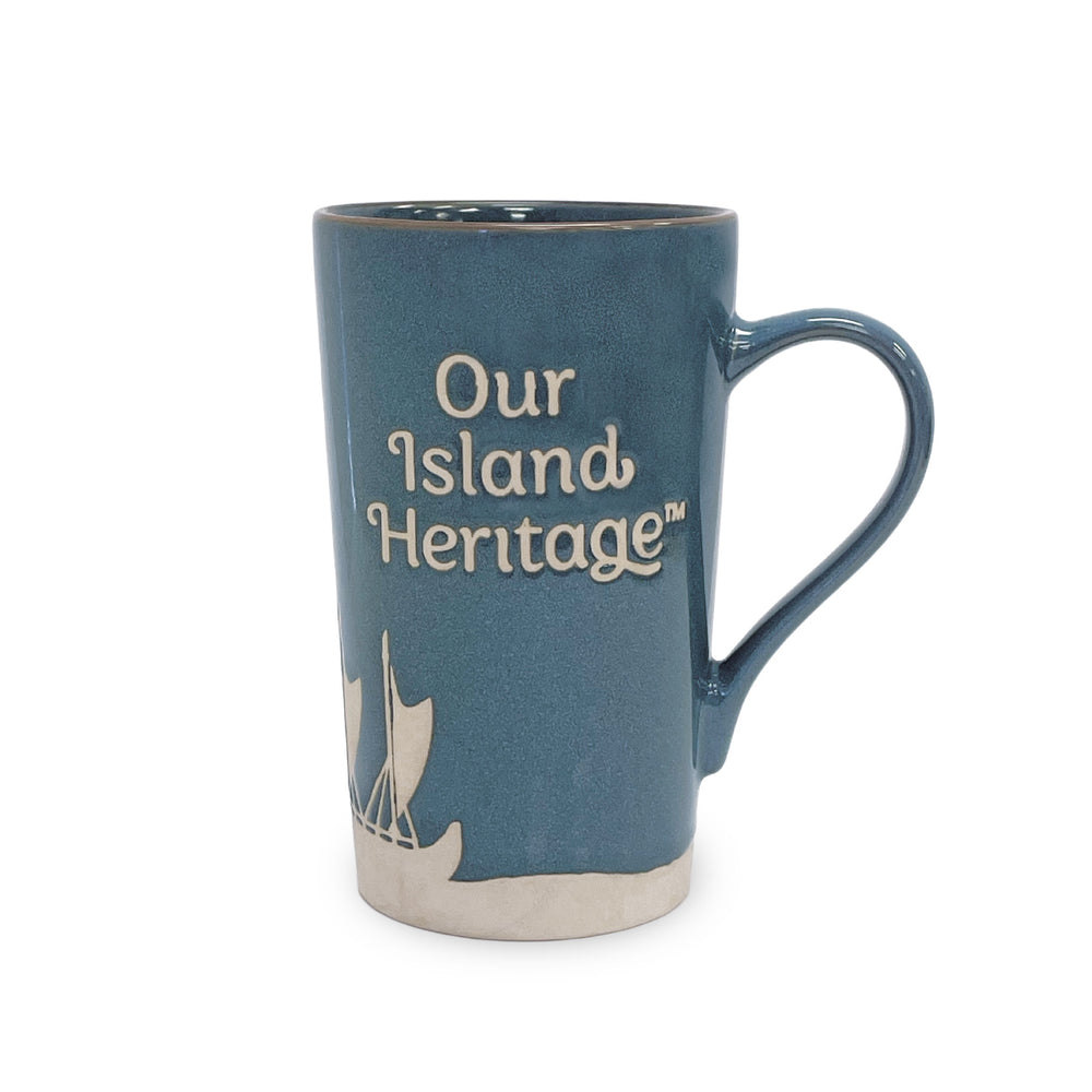 Blue mug with 'Our Island Heritage' text and sailboat design on a white background
