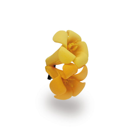 Yellow orange puakenikeni floral hair clip on a white background